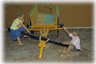 Children playing with a bullock cart